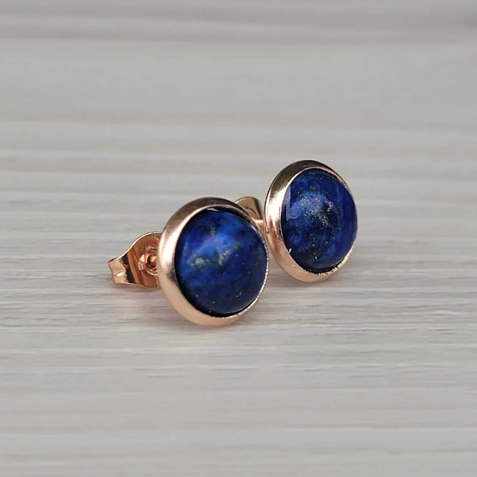Rose gold stud earrings with round blue lapis lazuli gemstones