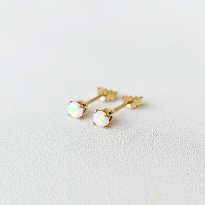 A pair of 14k gold-filled stud earrings with white opalite stones.
