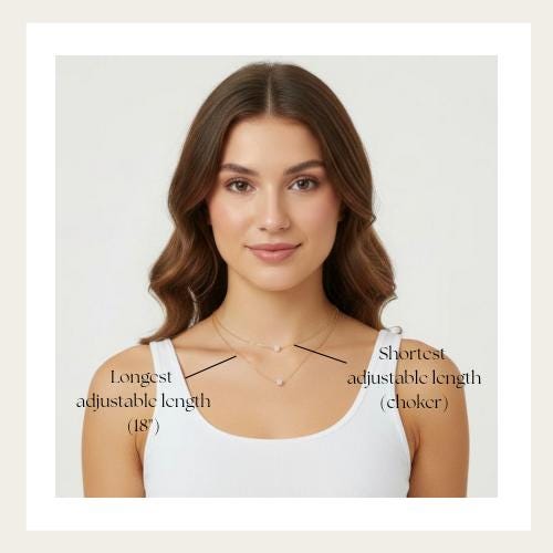 A woman with long brown hair wearing a white tank top and a necklace with adjustable lengths.