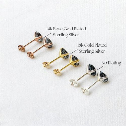 a collection of earrings, each with a different color and type of metal. The earrings are arranged in a row, showcasing their unique designs and characteristics.