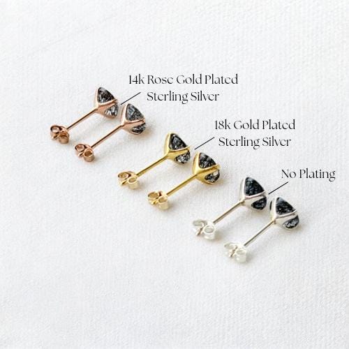 a collection of earrings, each with a different color and type of metal. The earrings are arranged in a row, showcasing their unique designs and characteristics.