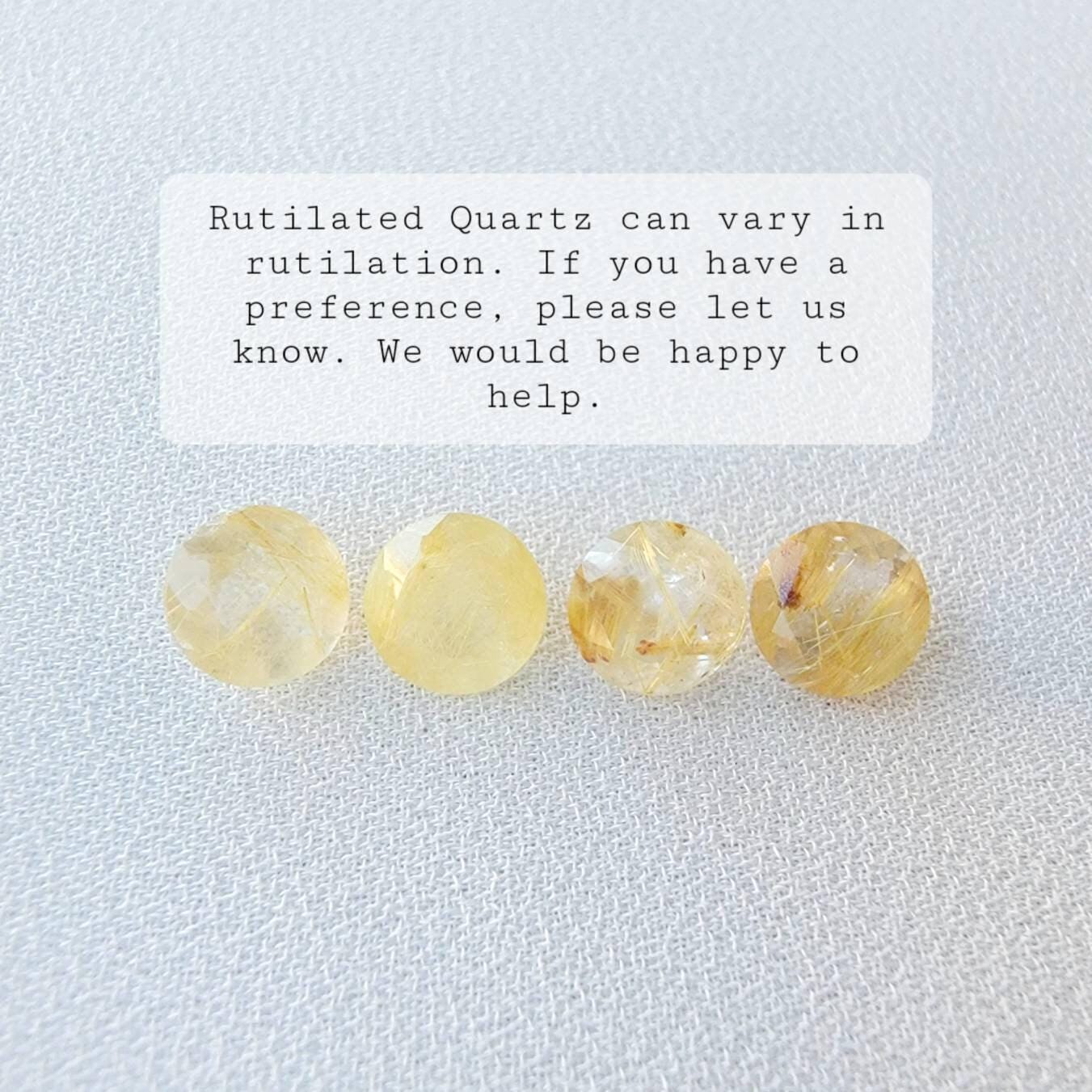 Four round, yellow rutilated quartz stones with gold inclusions. The stones are arranged in a row on a white surface. Rutilated Quartz can vary in rutilation. If you have a preference, please let us know. We would be happy to help.